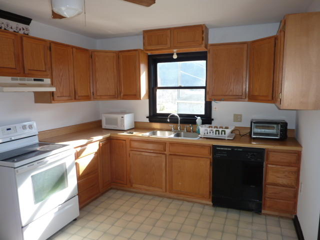 9700 Roanoke Road Elliston, VA 24087 - Photo 6 of 28 a kitchen with a sink stove and cabinets