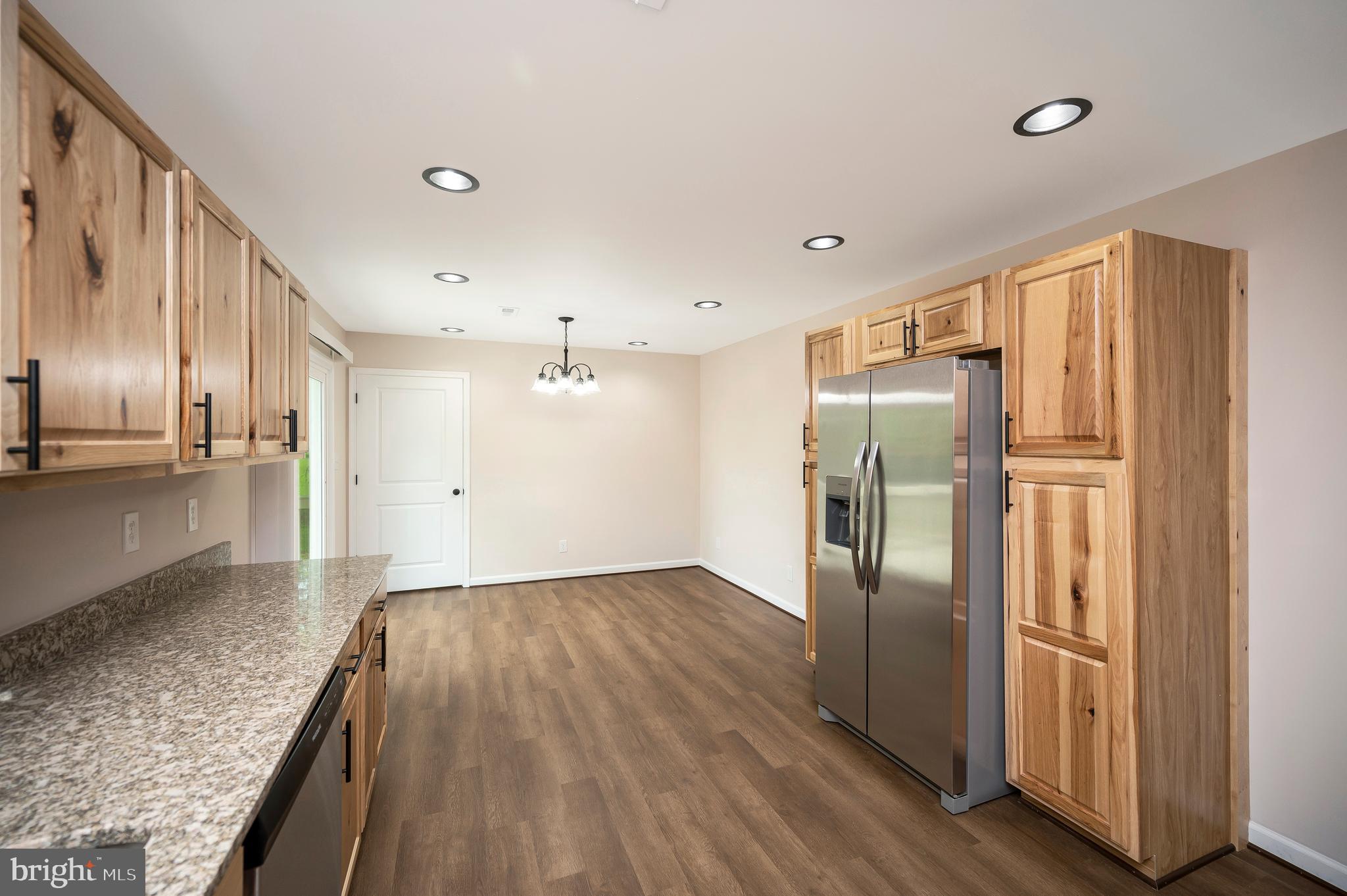 14169 Silver Hill Road Sumerduck, VA 22742 - Photo 10 of 40 a view of a refrigerator in kitchen and wooden floor