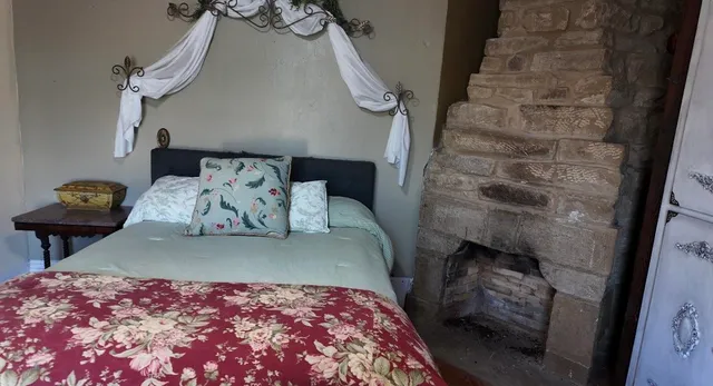 a bedroom with a bed and a chair in it