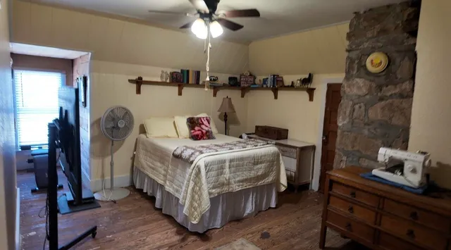 a bedroom with a bed and a chandelier