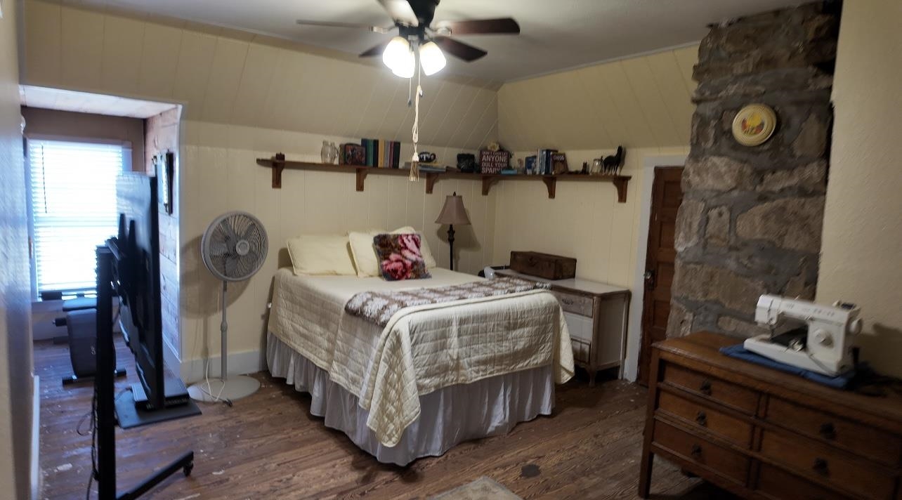 801 Mohawk Cherokee, TX 76832 - Photo 15 of 29 a bedroom with a bed and a chandelier
