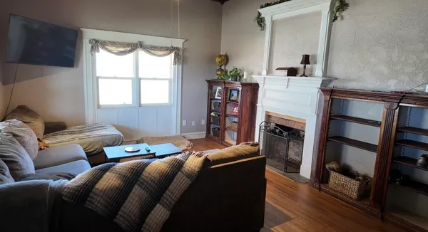 a living room with furniture and a fireplace