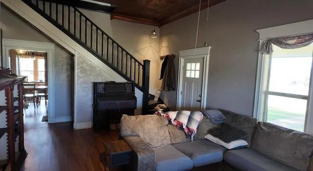 a living room with furniture and wooden floor