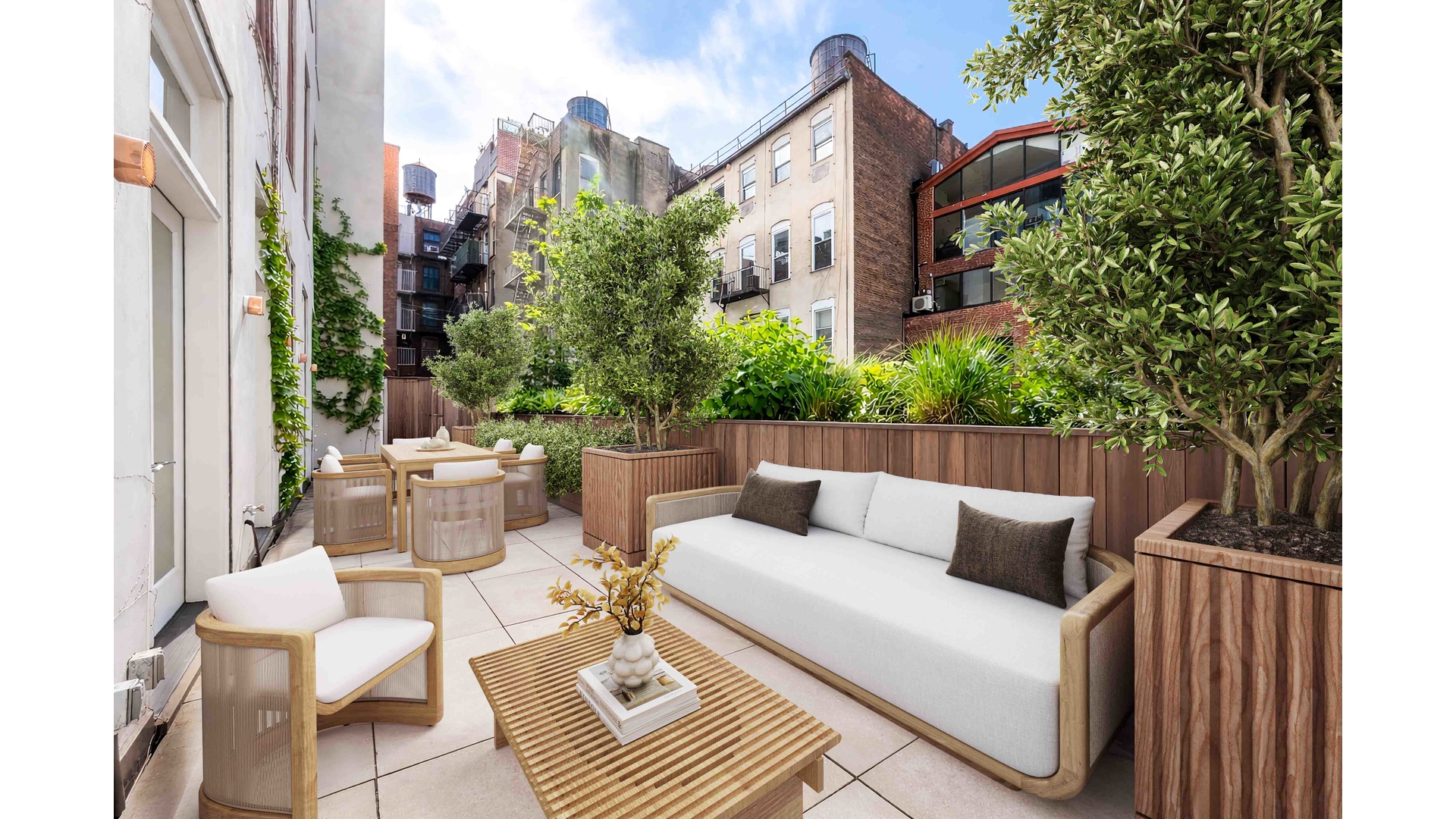 43 Wooster Street, Unit 2W Manhattan, NY 10013 - Photo 2 of 9 a view of a patio with couches table and chairs and potted plants