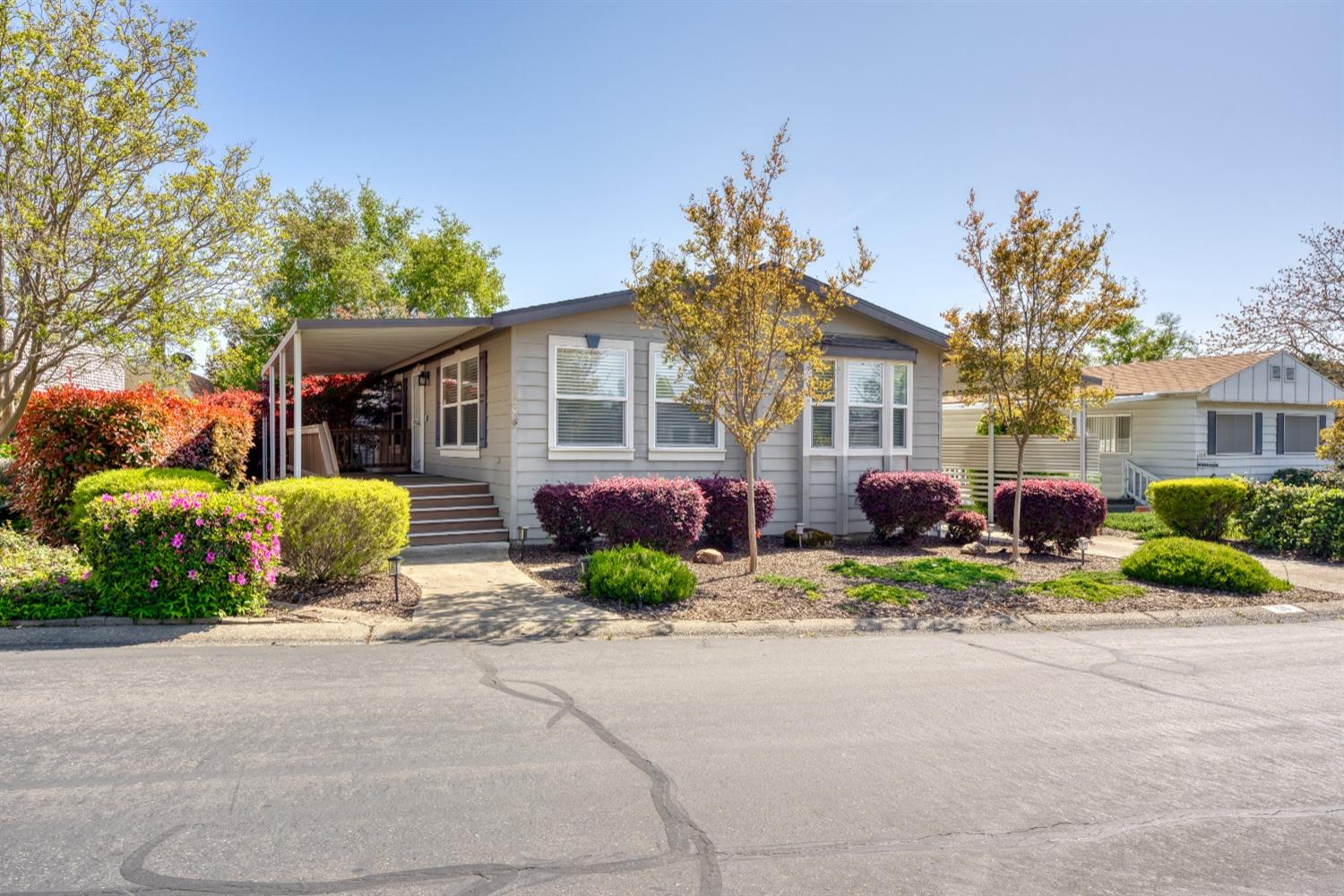 a front view of a house with a garden and porch