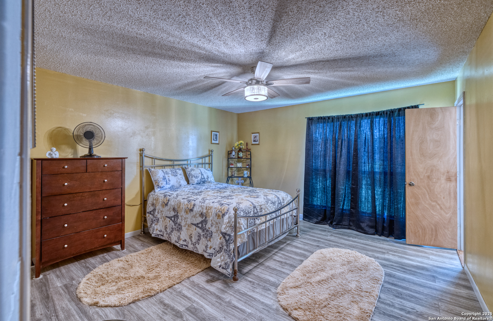 121 Rio Grande Street Uvalde, TX 78801 - Photo 11 of 29 a bedroom with a bed and a dresser