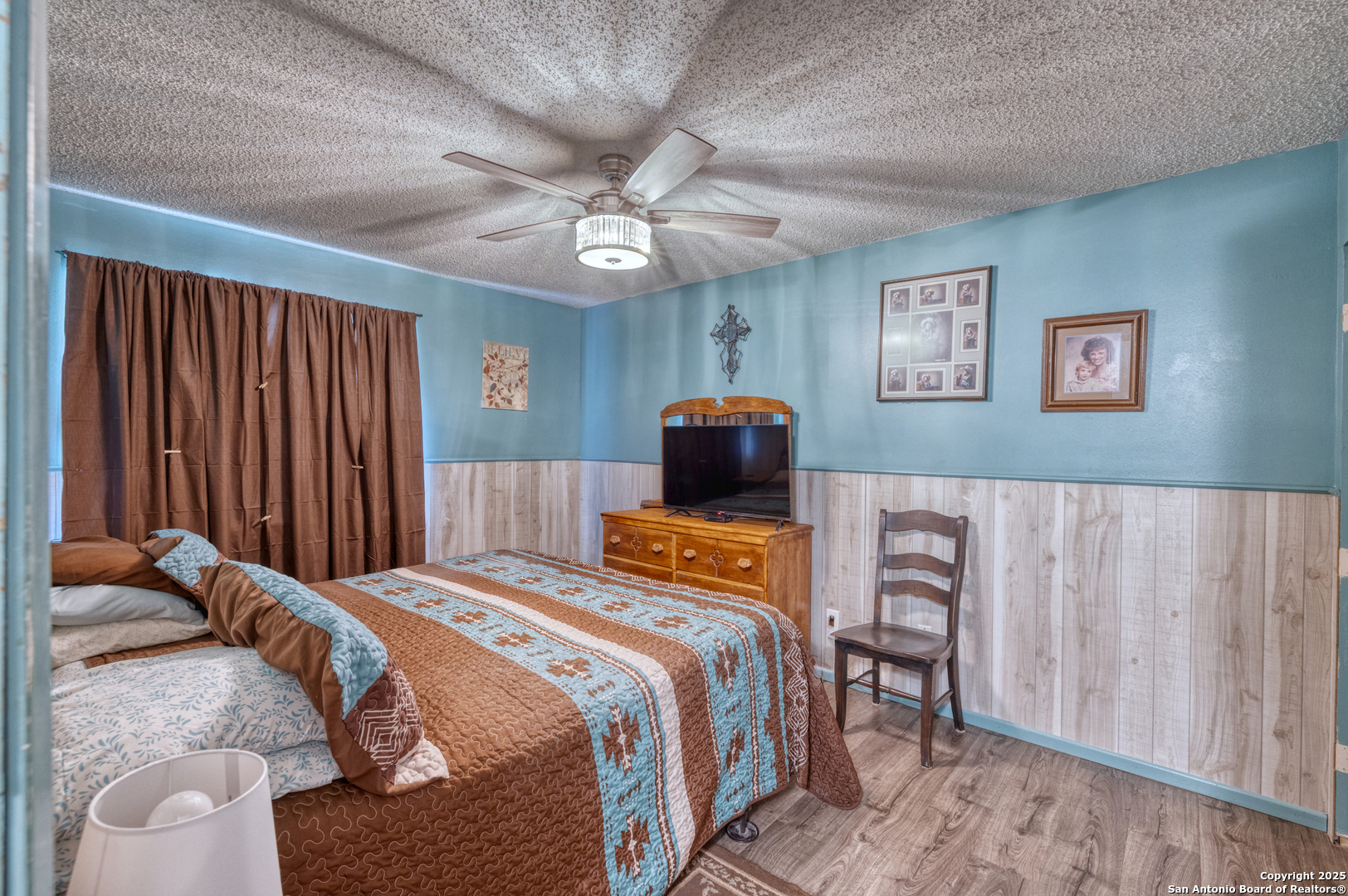 121 Rio Grande Street Uvalde, TX 78801 - Photo 13 of 29 a bedroom with bed and wooden floor