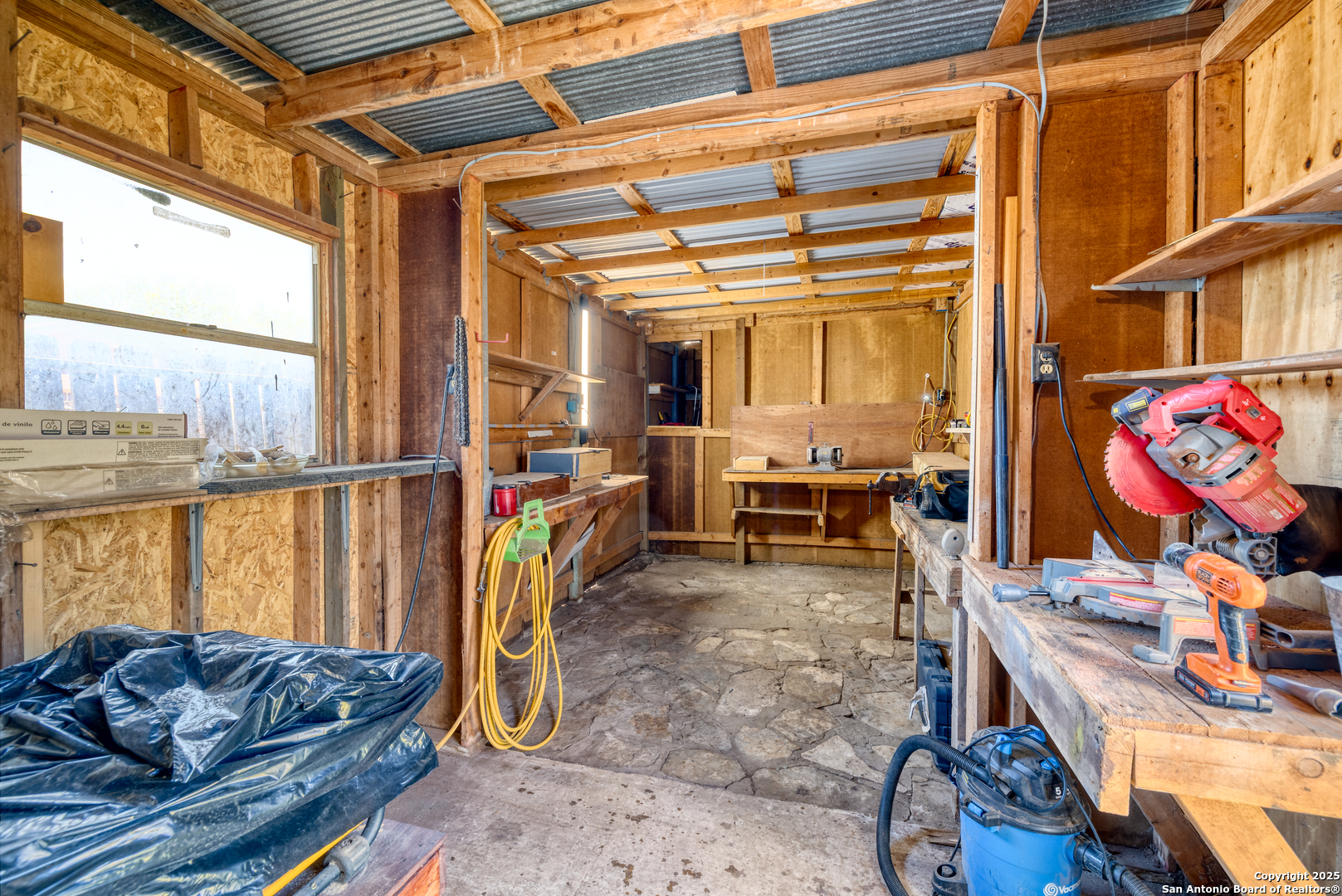 121 Rio Grande Street Uvalde, TX 78801 - Photo 20 of 29 a living room with patio furniture and a floor to ceiling window