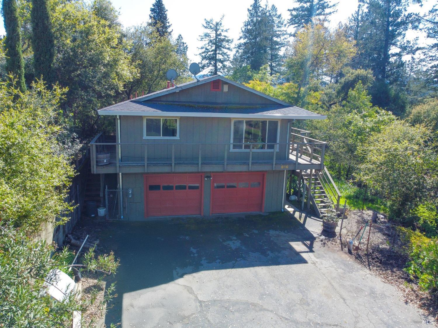 a front view of a house with a yard and a garage