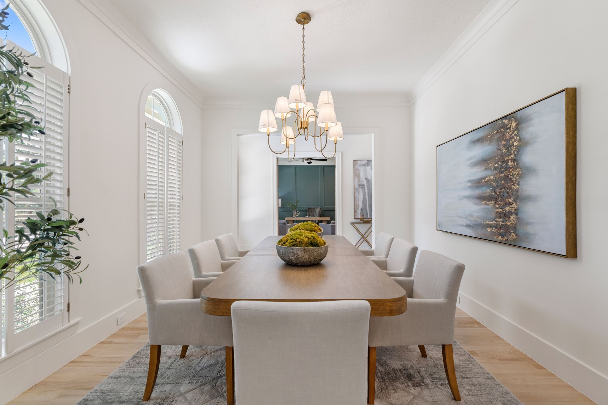 31 Hollymead Drive Spring, TX 77381 - Photo 11 of 50 The dining room features a modern chandelier (2026), and large windows with shutters, providing ample natural light is located just off the Foyer at the front of the home.