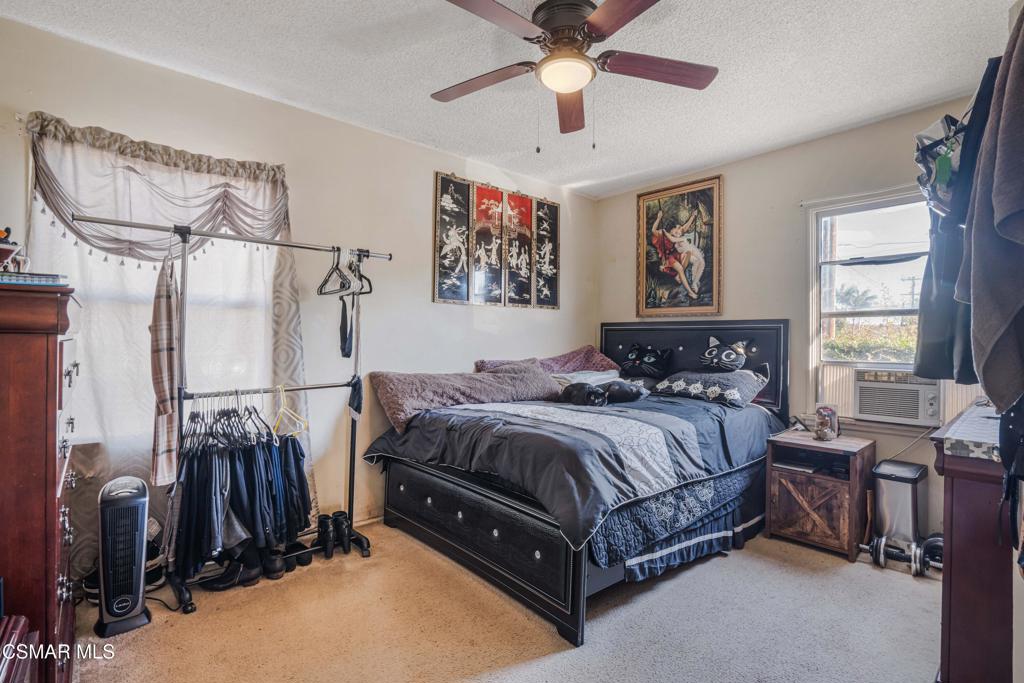 344 North 1st Street Montebello, CA 90640 - Photo 11 of 16 a bedroom with a bed and a chandelier