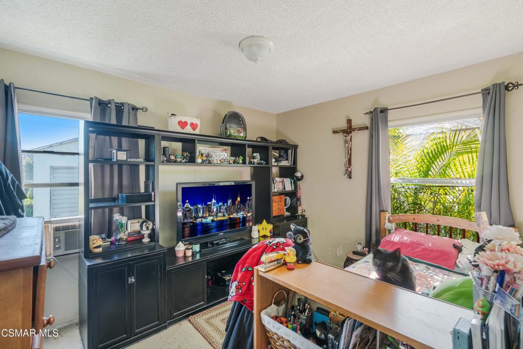 344 North 1st Street Montebello, CA 90640 - Photo 12 of 16 a living room with furniture a flat screen tv and a fireplace