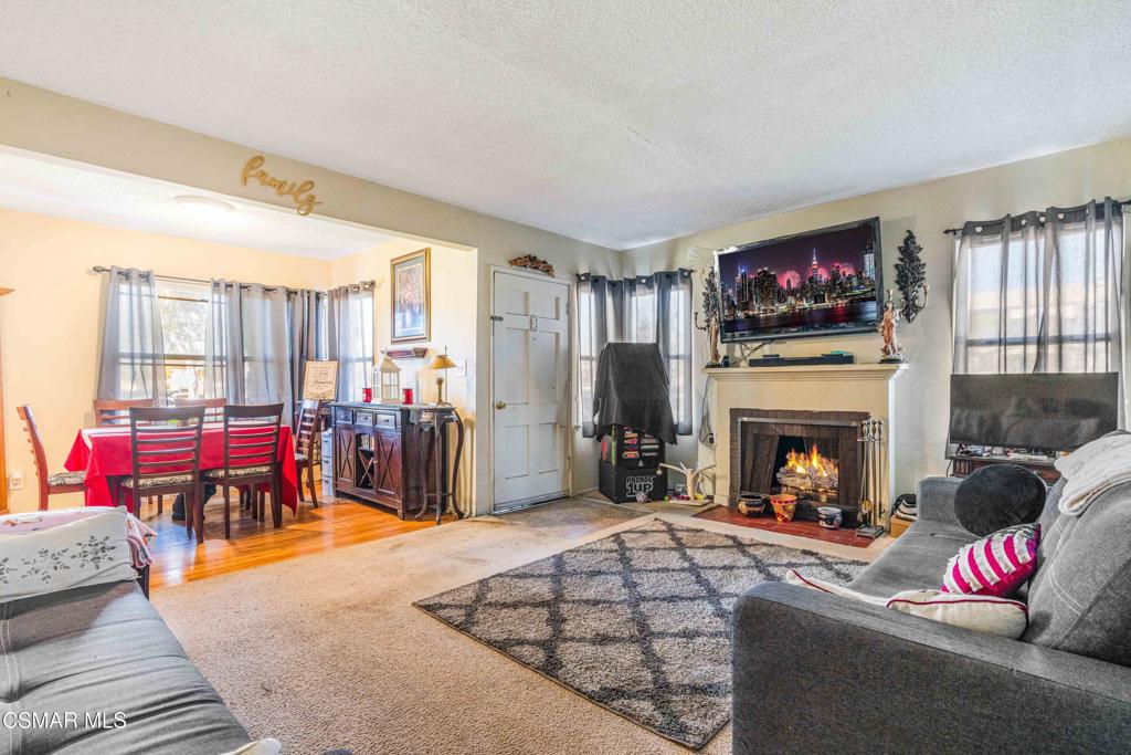 344 North 1st Street Montebello, CA 90640 - Photo 4 of 16 a living room with furniture a fireplace and a flat screen tv