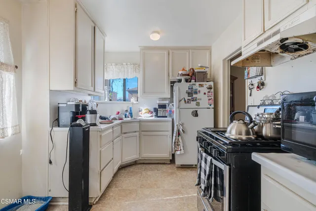 a kitchen with a sink stove and refrigerator