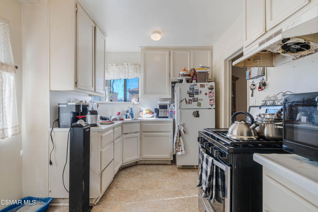 344 North 1st Street Montebello, CA 90640 - Photo 8 of 16 a kitchen with a sink stove and refrigerator