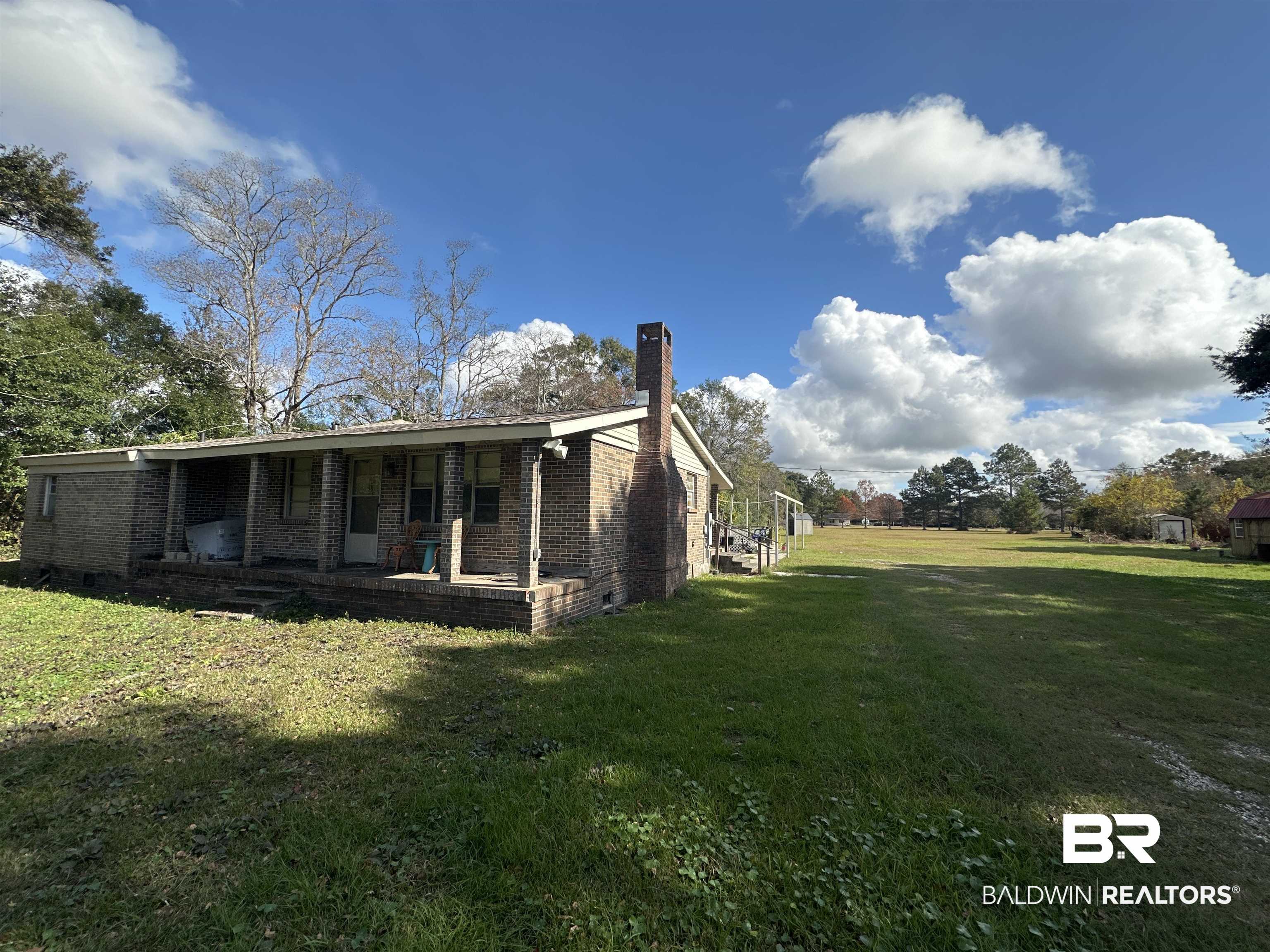 9520 C Four Mile Road Irvington, AL 36544 - Photo 4 of 32 View of side of home with a yard