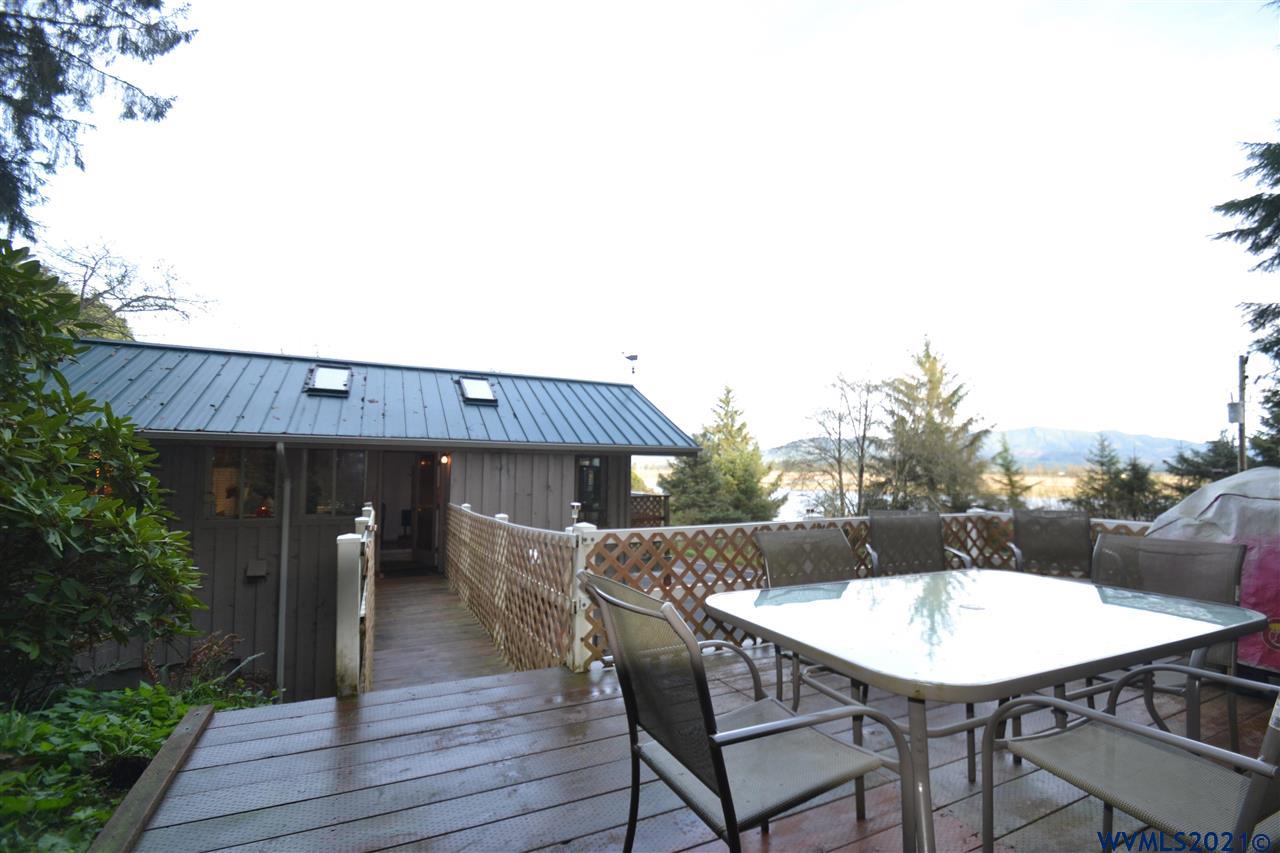 1690 Bayocean Road Northwest Tillamook, OR 97141 - Photo 20 of 25 a roof deck with table and chairs potted plants and wooden floor