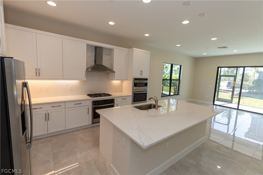 12801 Springbrook Court Estero, FL 33928 - Photo 17 of 49 a kitchen with a sink stove and refrigerator