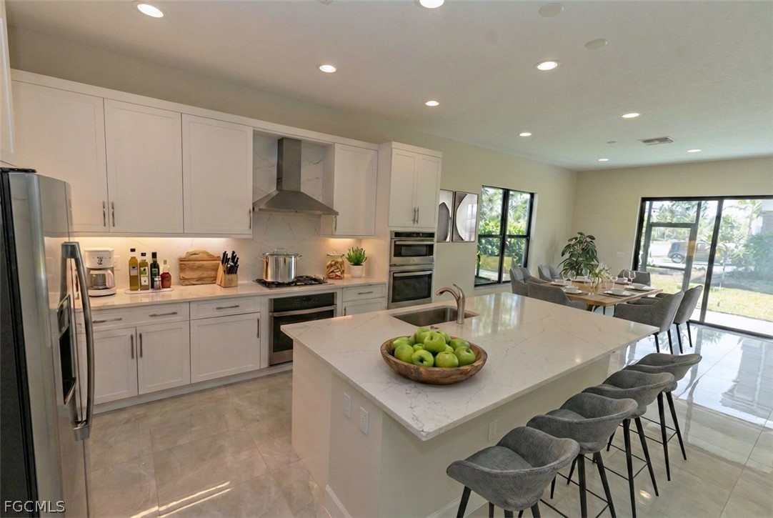 12801 Springbrook Court Estero, FL 33928 - Photo 2 of 49 a kitchen with sink a stove and refrigerator