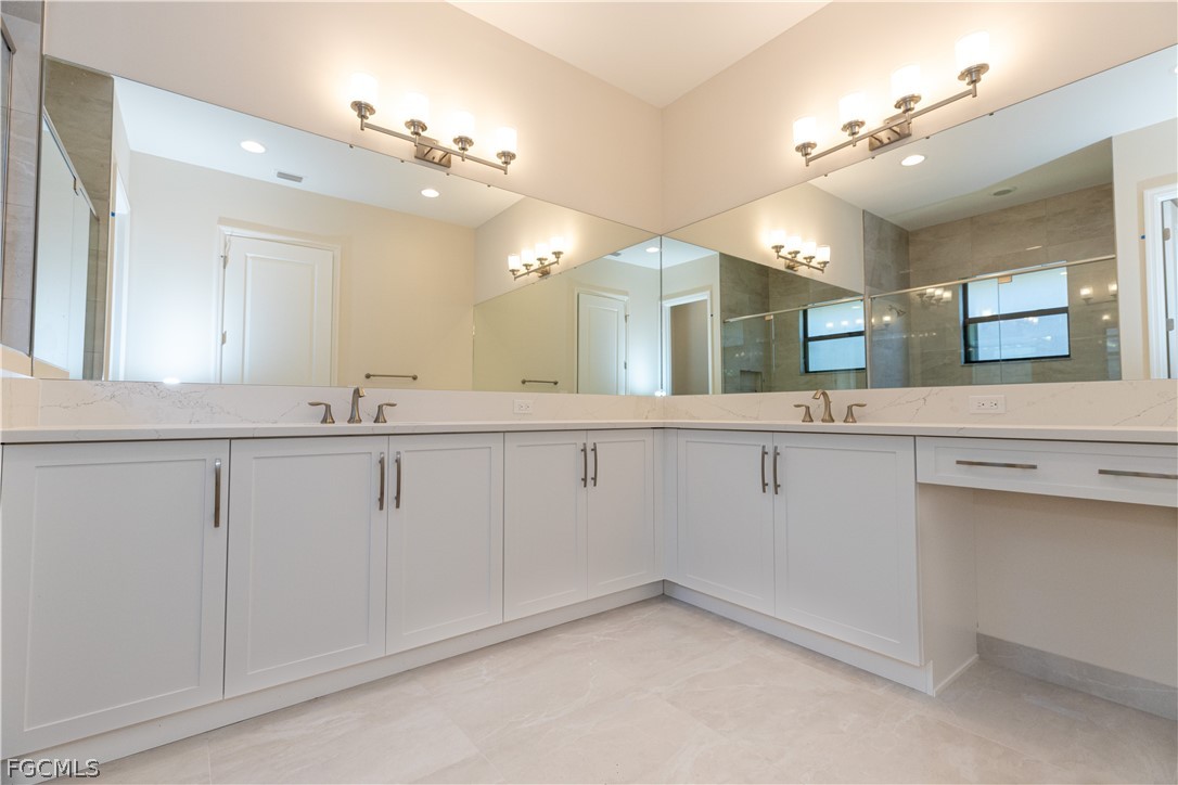 12801 Springbrook Court Estero, FL 33928 - Photo 25 of 49 a bathroom with a sink vanity and mirror