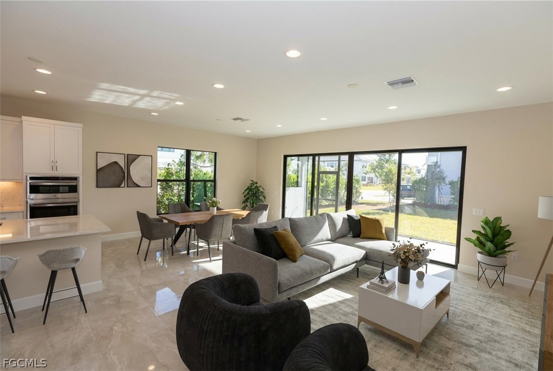 12801 Springbrook Court Estero, FL 33928 - Photo 3 of 49 a living room with furniture and a large window