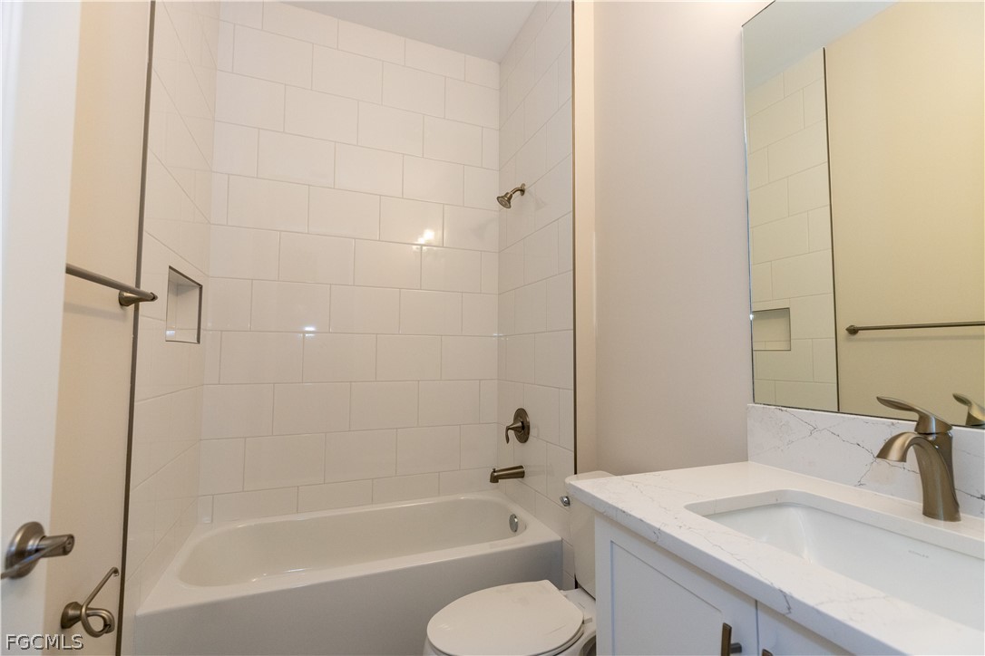 12801 Springbrook Court Estero, FL 33928 - Photo 32 of 49 a bathroom with a sink toilet and shower