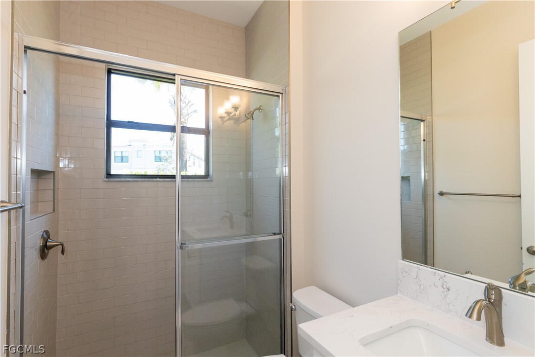 12801 Springbrook Court Estero, FL 33928 - Photo 33 of 49 a bathroom with a sink and a mirror