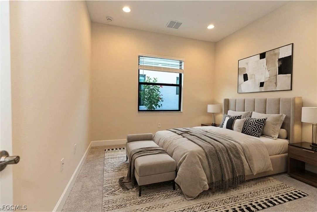 12801 Springbrook Court Estero, FL 33928 - Photo 7 of 49 a bedroom with a bed and a painting on the wall