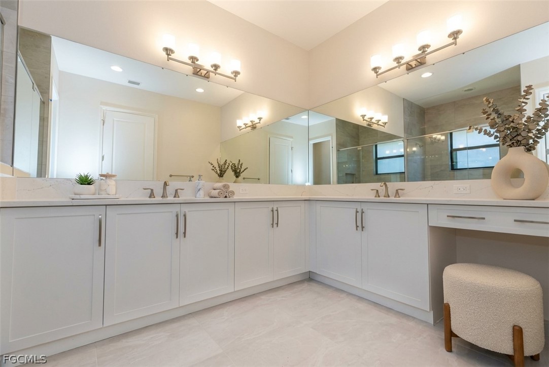 12801 Springbrook Court Estero, FL 33928 - Photo 8 of 49 a bathroom with a sink vanity and mirror