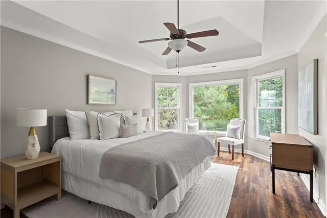 a bedroom with a large bed and a large window