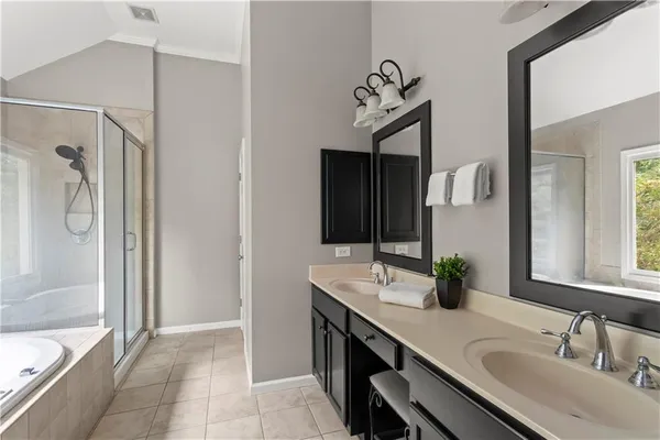a bathroom with a double vanity sink mirror and shower