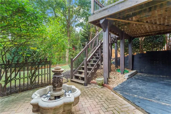 a front view of a house with fountain bath tub and wooden fence