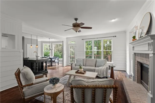 a living room with furniture fireplace and a large window