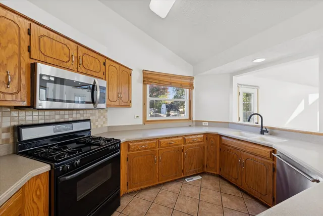 a kitchen with a sink stove top oven and cabinets
