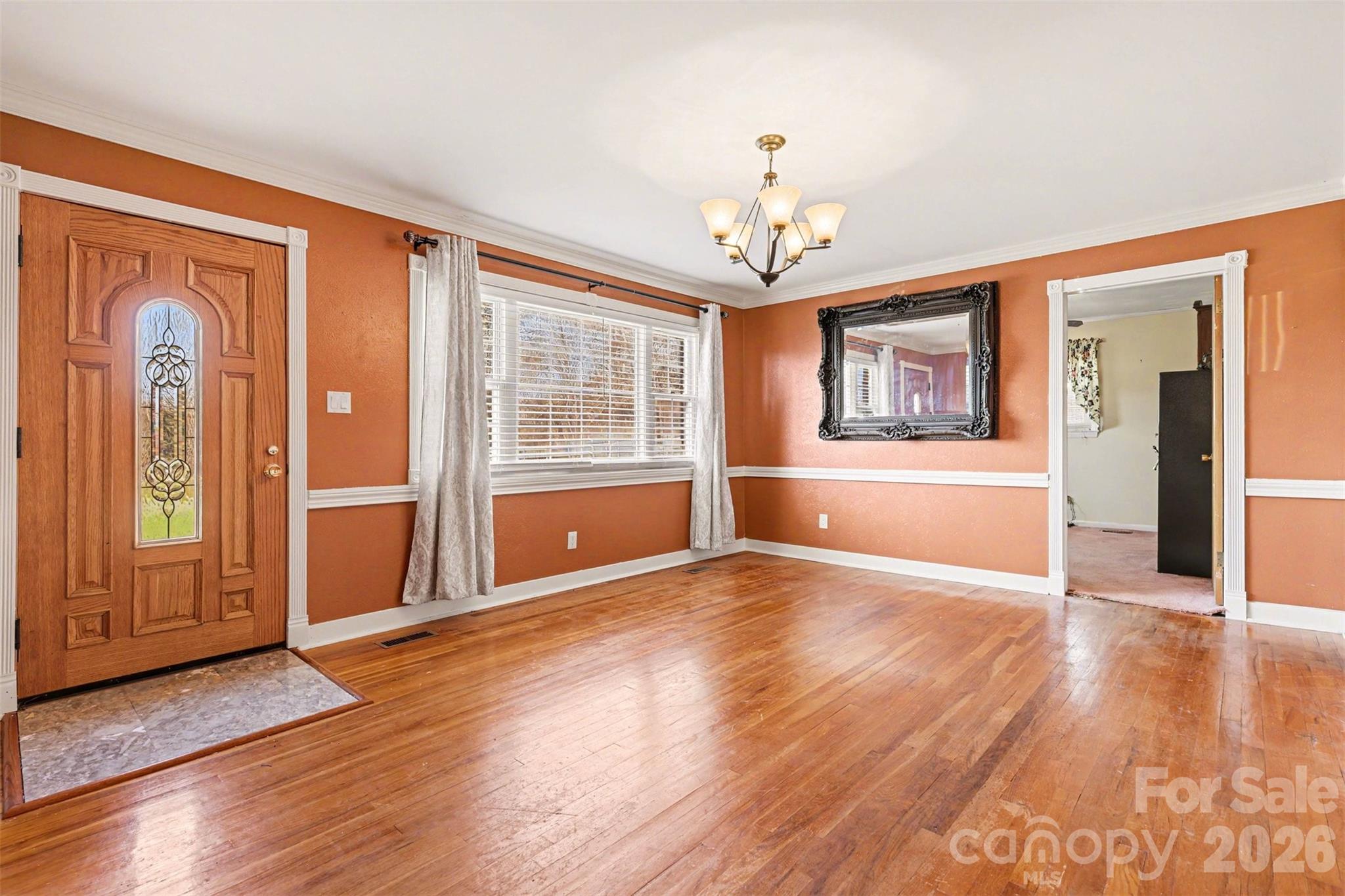 6501 Casar Road Casar, NC 28020 - Photo 4 of 45 an empty room with wooden floor chandelier and windows