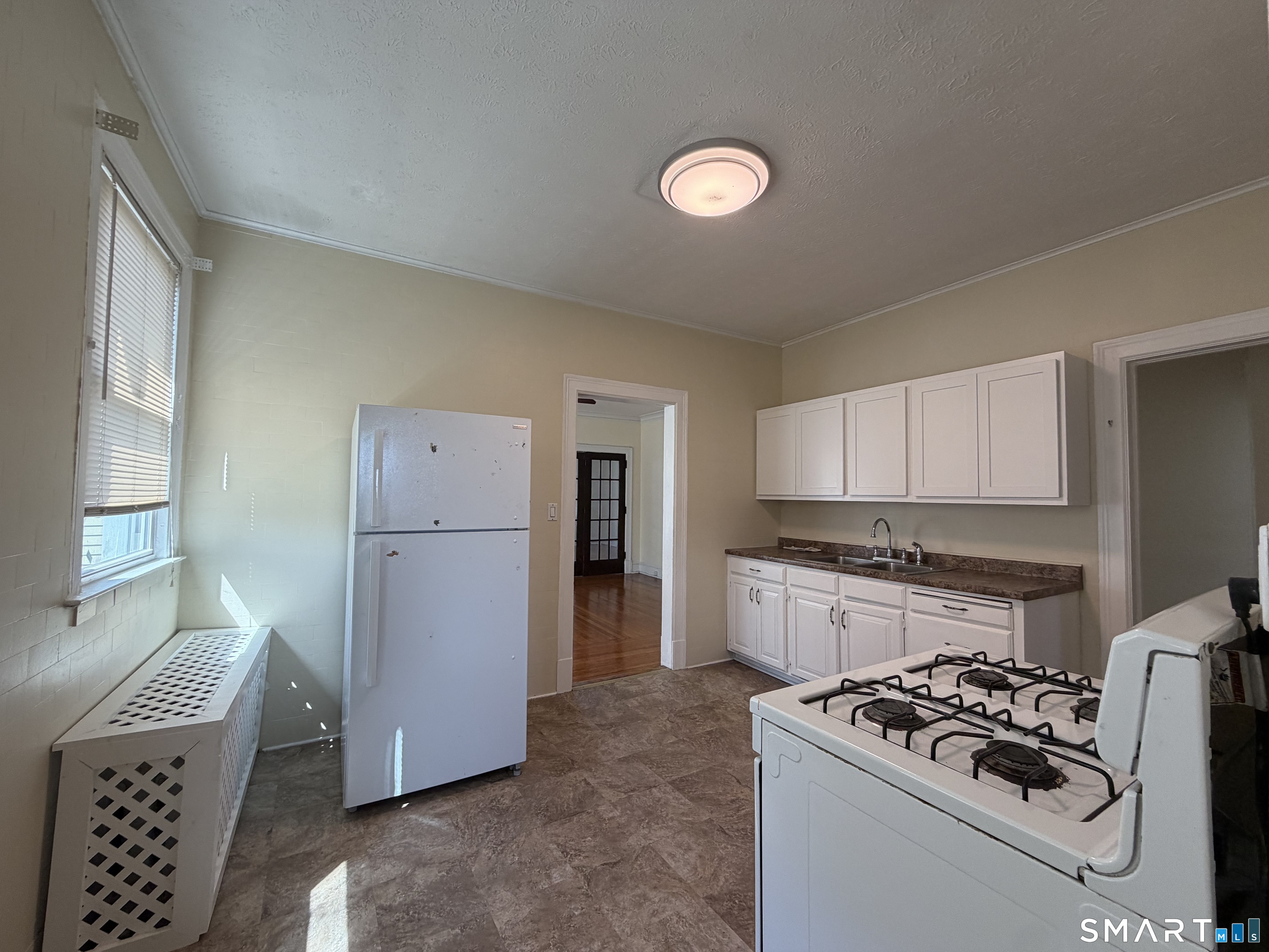 41-43 Hebron Street Hartford, CT 06112 - Photo 11 of 13 a kitchen with a white stove top oven and refrigerator