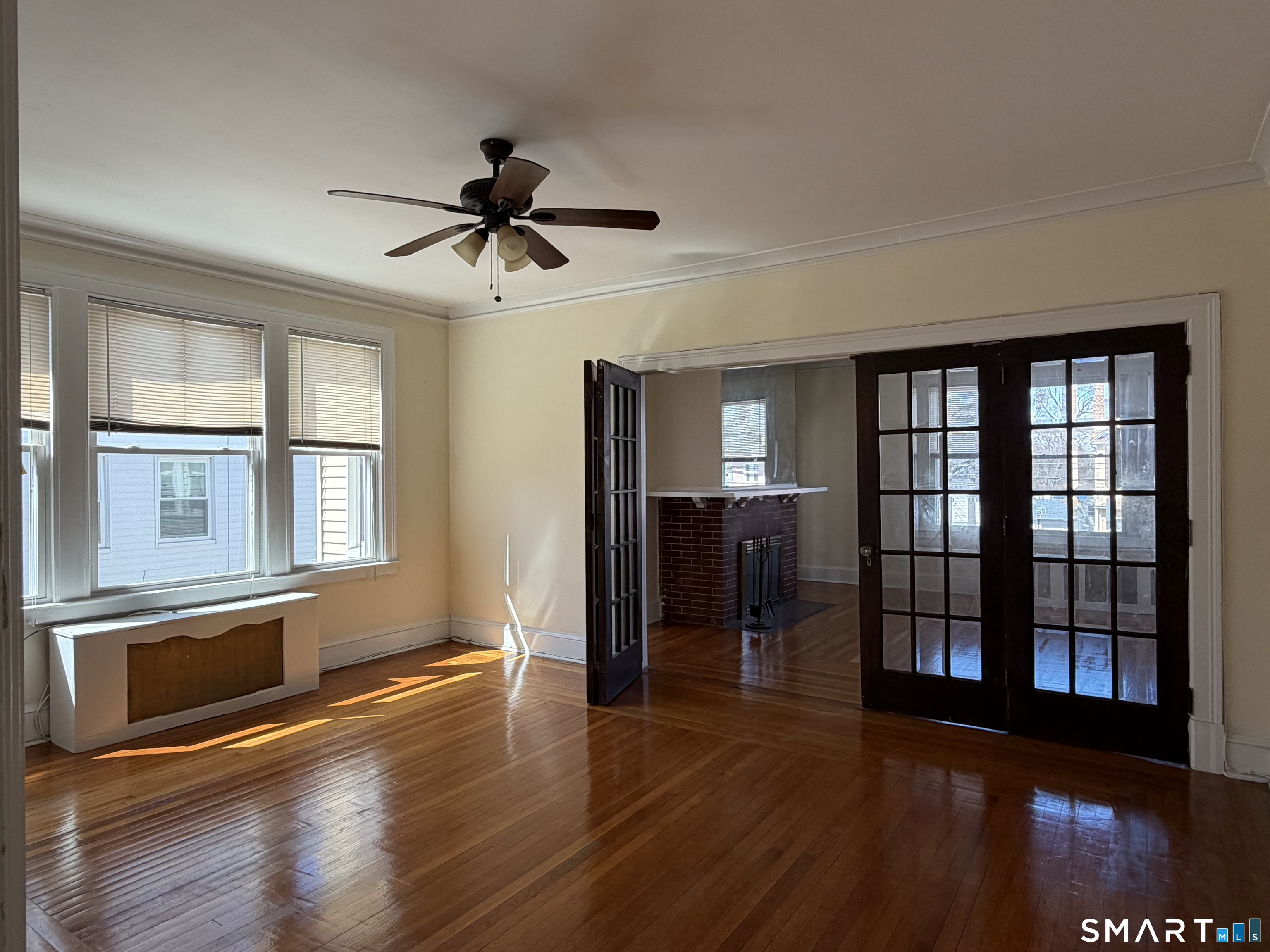 41-43 Hebron Street Hartford, CT 06112 - Photo 12 of 13 a view of a livingroom with wooden floor and a ceiling fan
