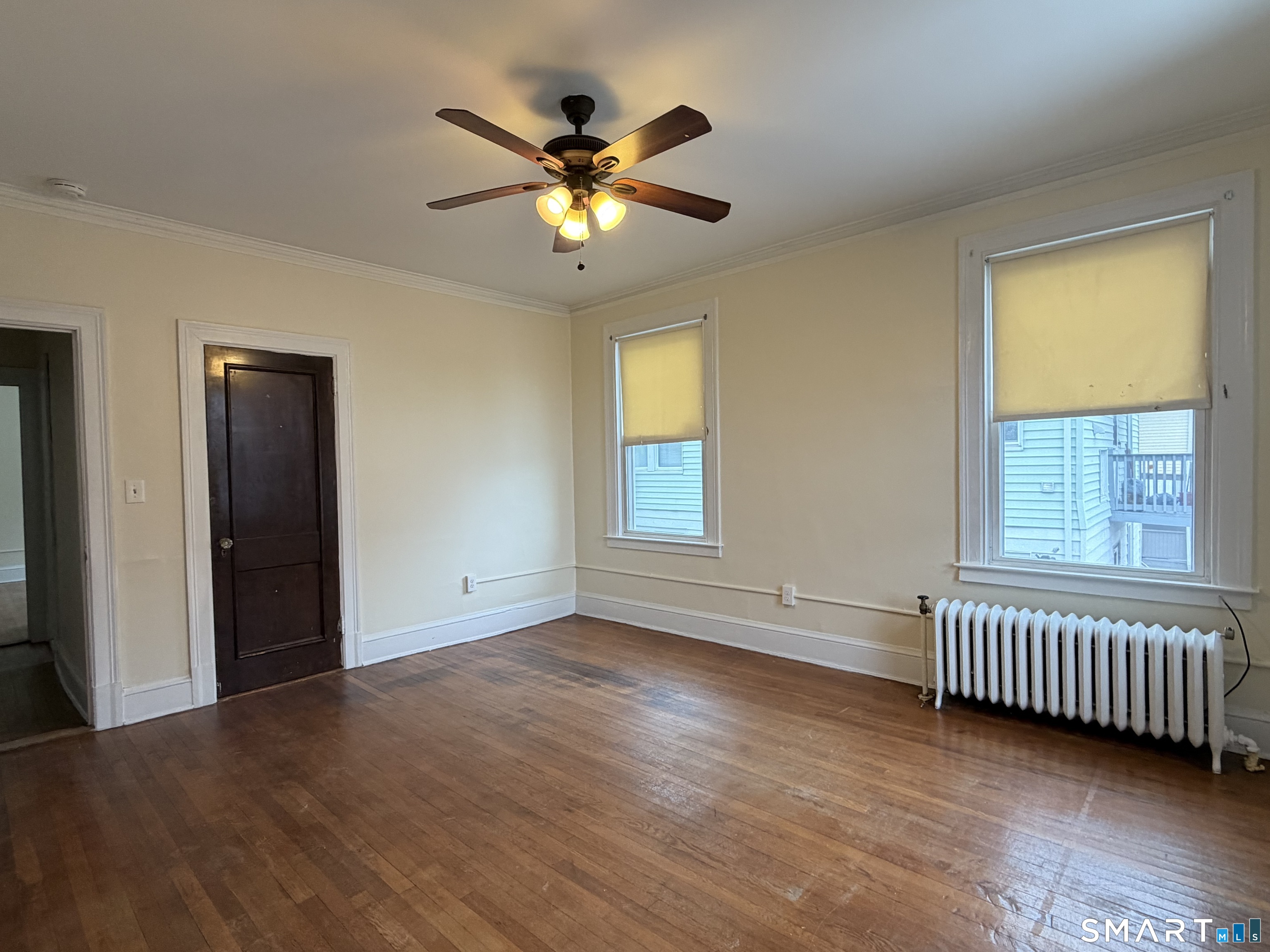 41-43 Hebron Street Hartford, CT 06112 - Photo 2 of 13 a view of an empty room with window and wooden floor