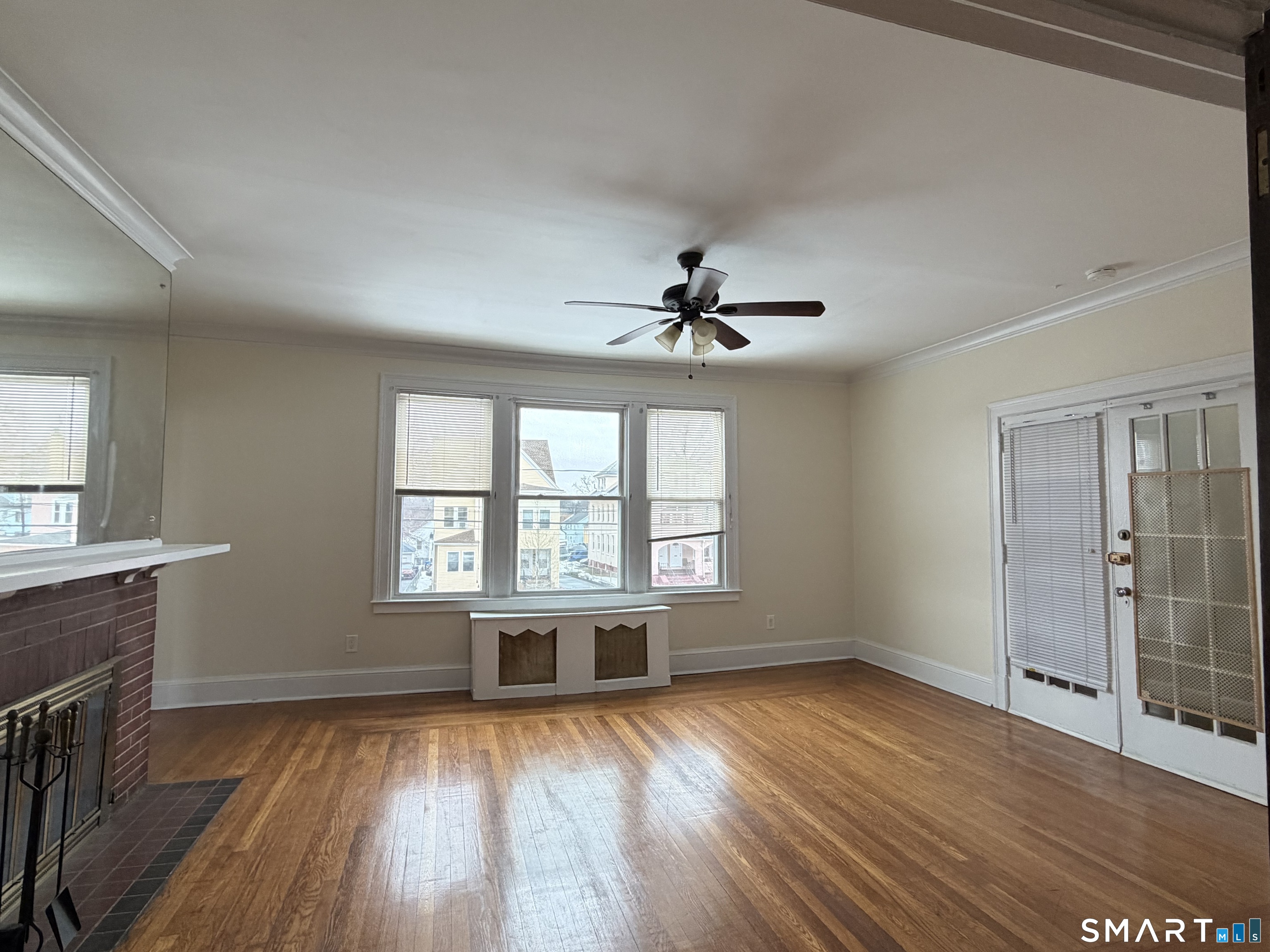 41-43 Hebron Street Hartford, CT 06112 - Photo 4 of 13 a view of an empty room with wooden floor and a window