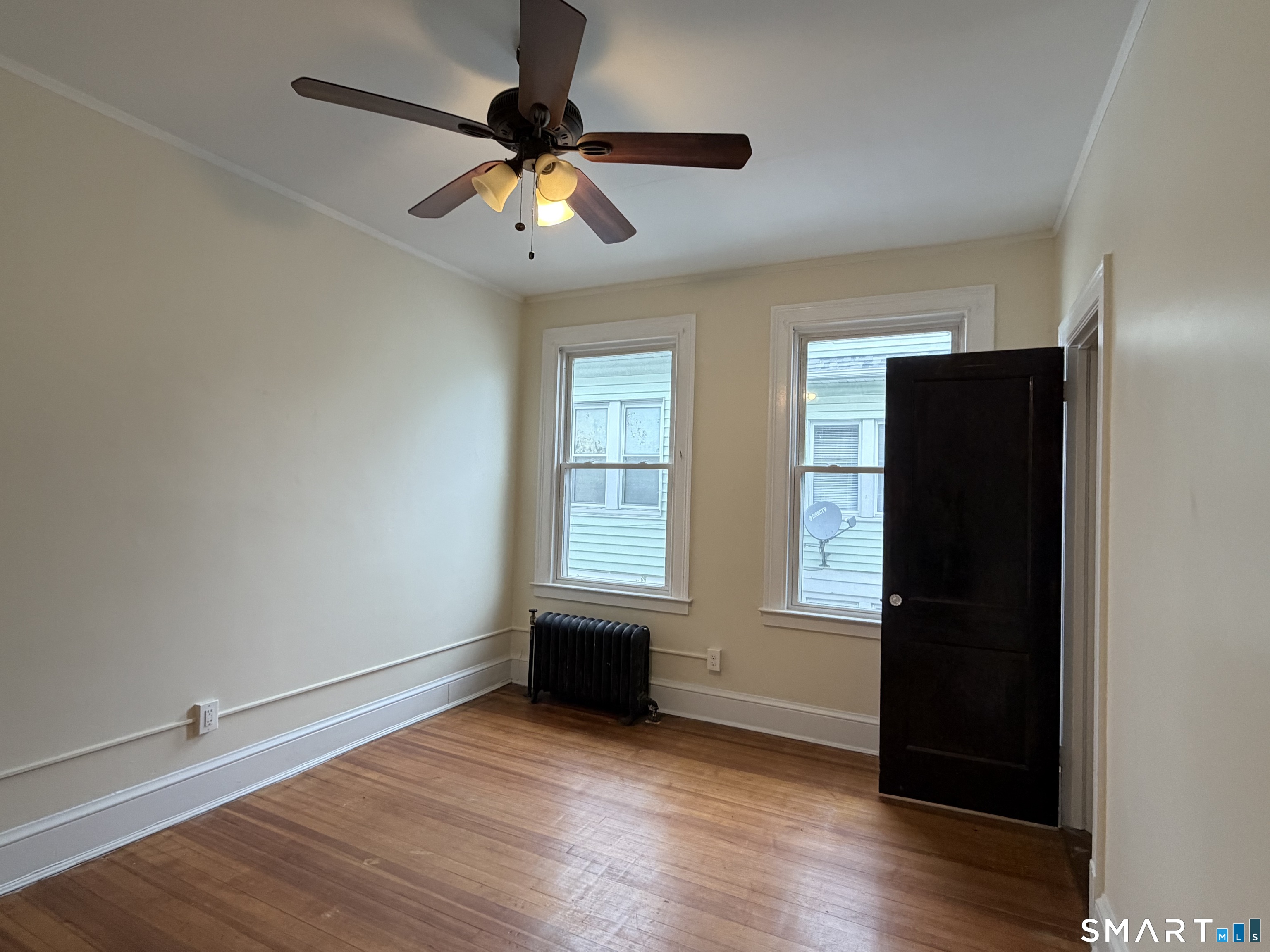41-43 Hebron Street Hartford, CT 06112 - Photo 6 of 13 an empty room with wooden floor closet and windows