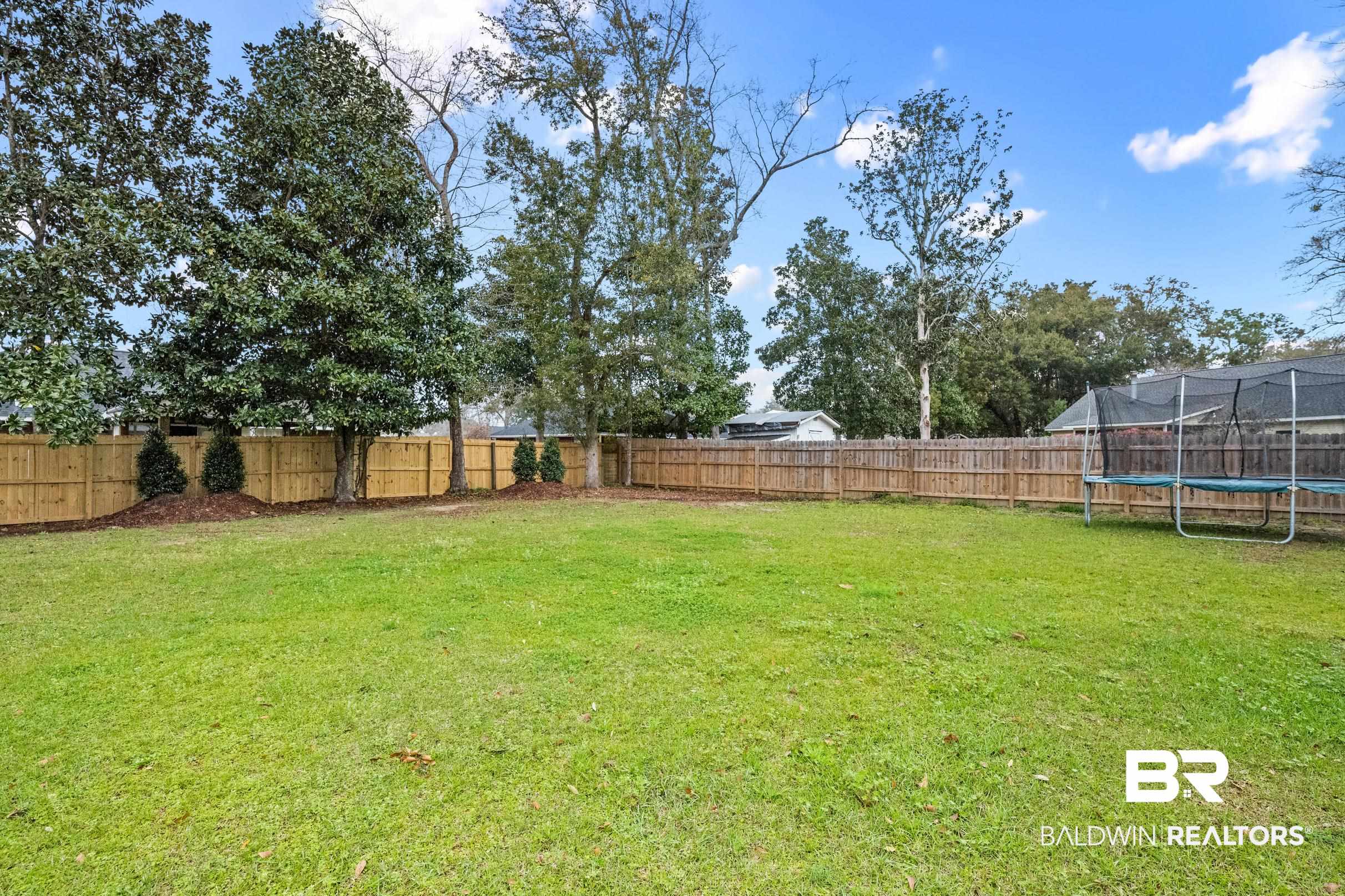 6 Wren Circle Foley, AL 36535 - Photo 46 of 55 View of yard with a trampoline and a fenced backyard