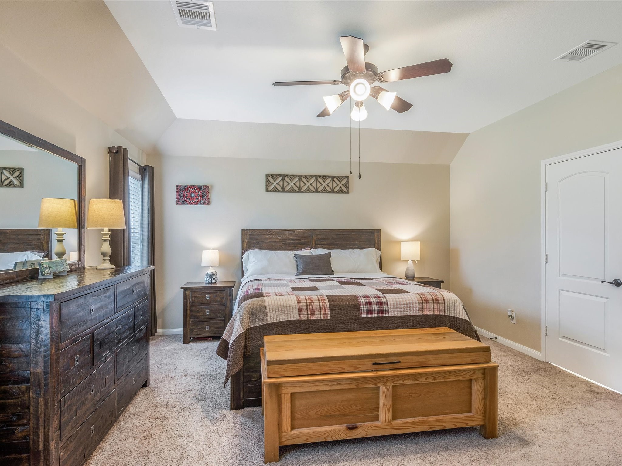 18746 Encinal Trail Magnolia, TX 77355 - Photo 16 of 35 a bedroom with a bed and a chandelier