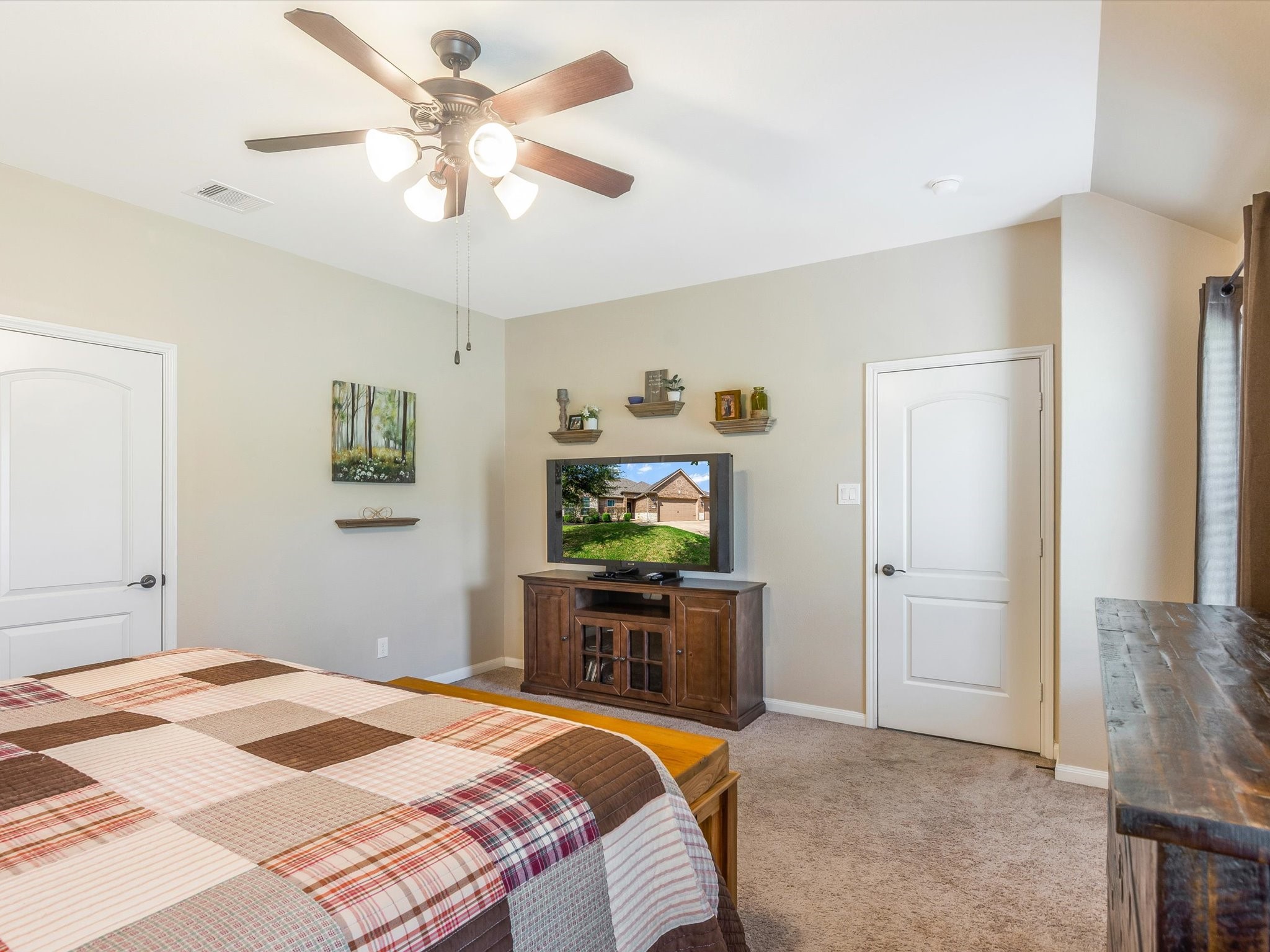 18746 Encinal Trail Magnolia, TX 77355 - Photo 18 of 35 a bedroom with a bed and a chandelier