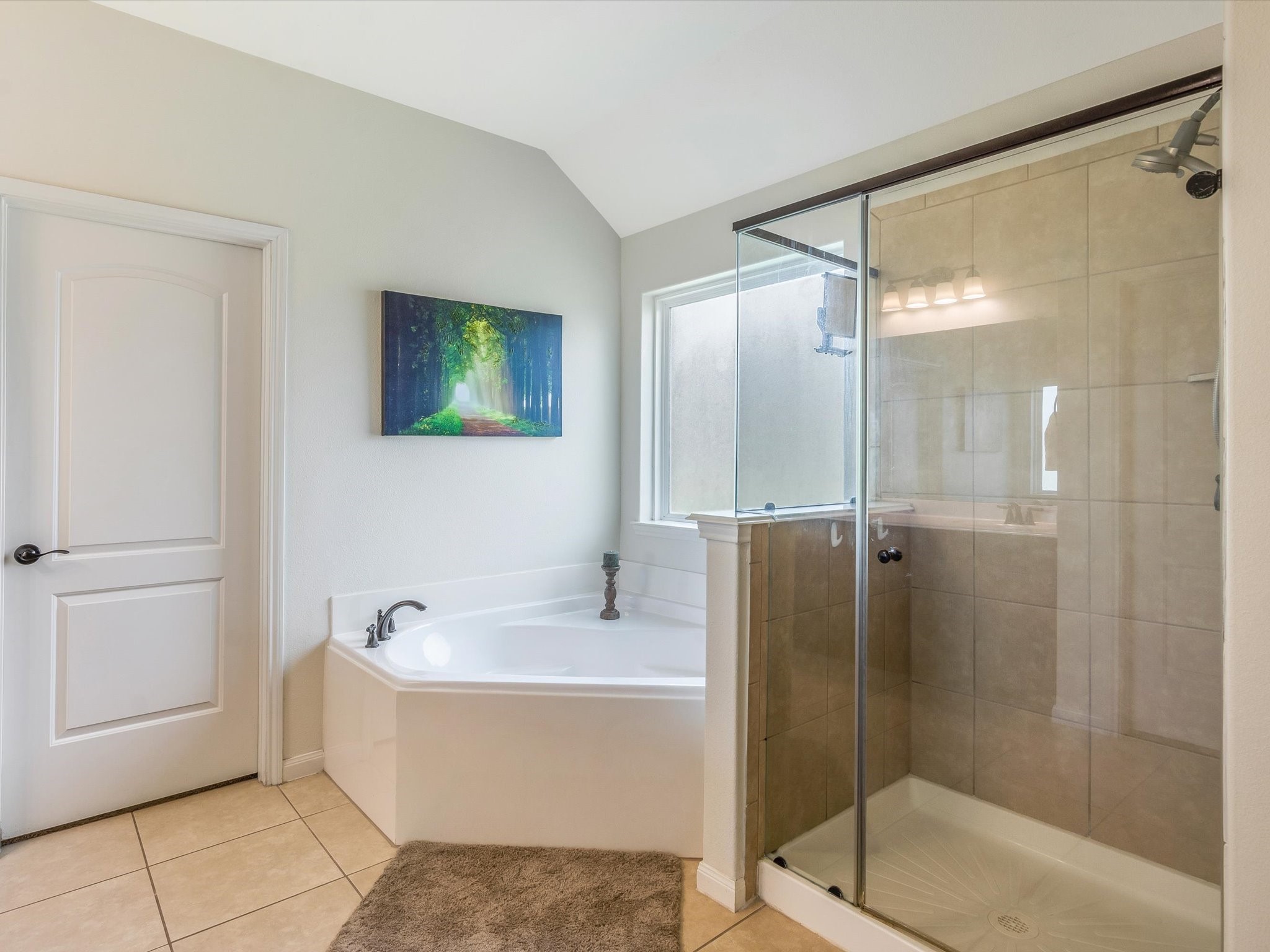 18746 Encinal Trail Magnolia, TX 77355 - Photo 21 of 35 a bathroom with a bathtub and a shower