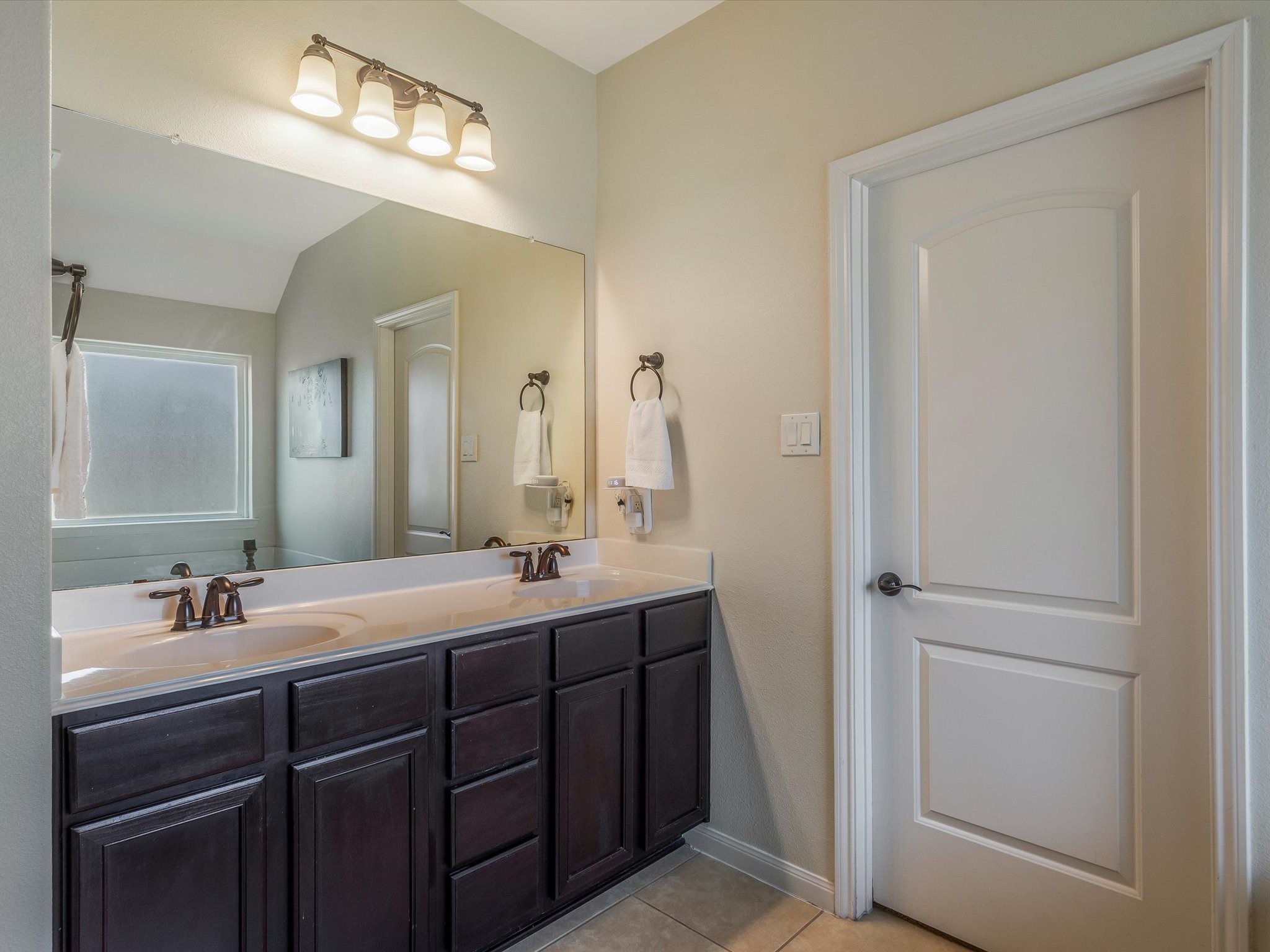 18746 Encinal Trail Magnolia, TX 77355 - Photo 22 of 35 a bathroom with a double vanity sink and a mirror