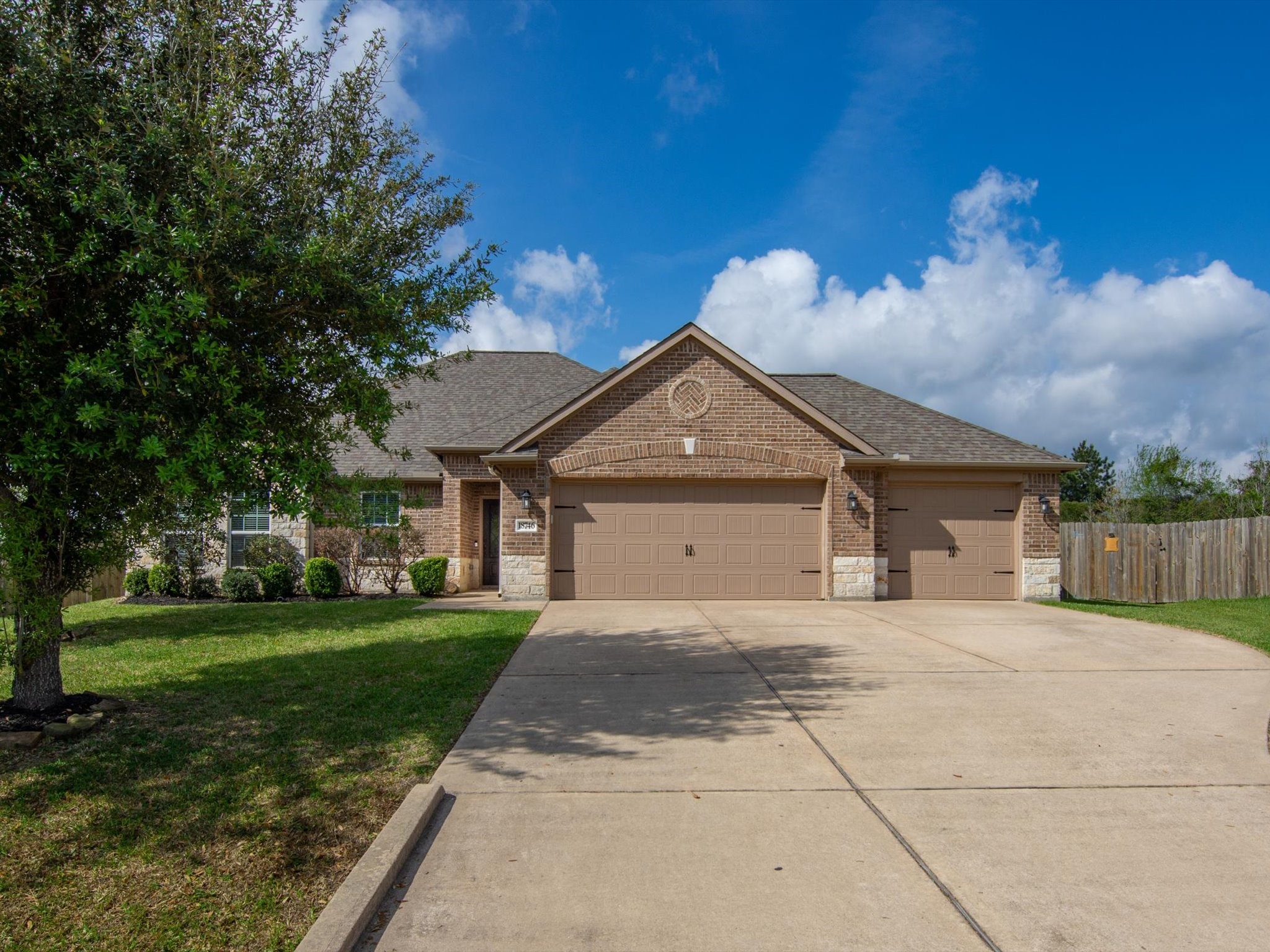 18746 Encinal Trail Magnolia, TX 77355 - Photo 3 of 35 a front view of a house with a yard and garage