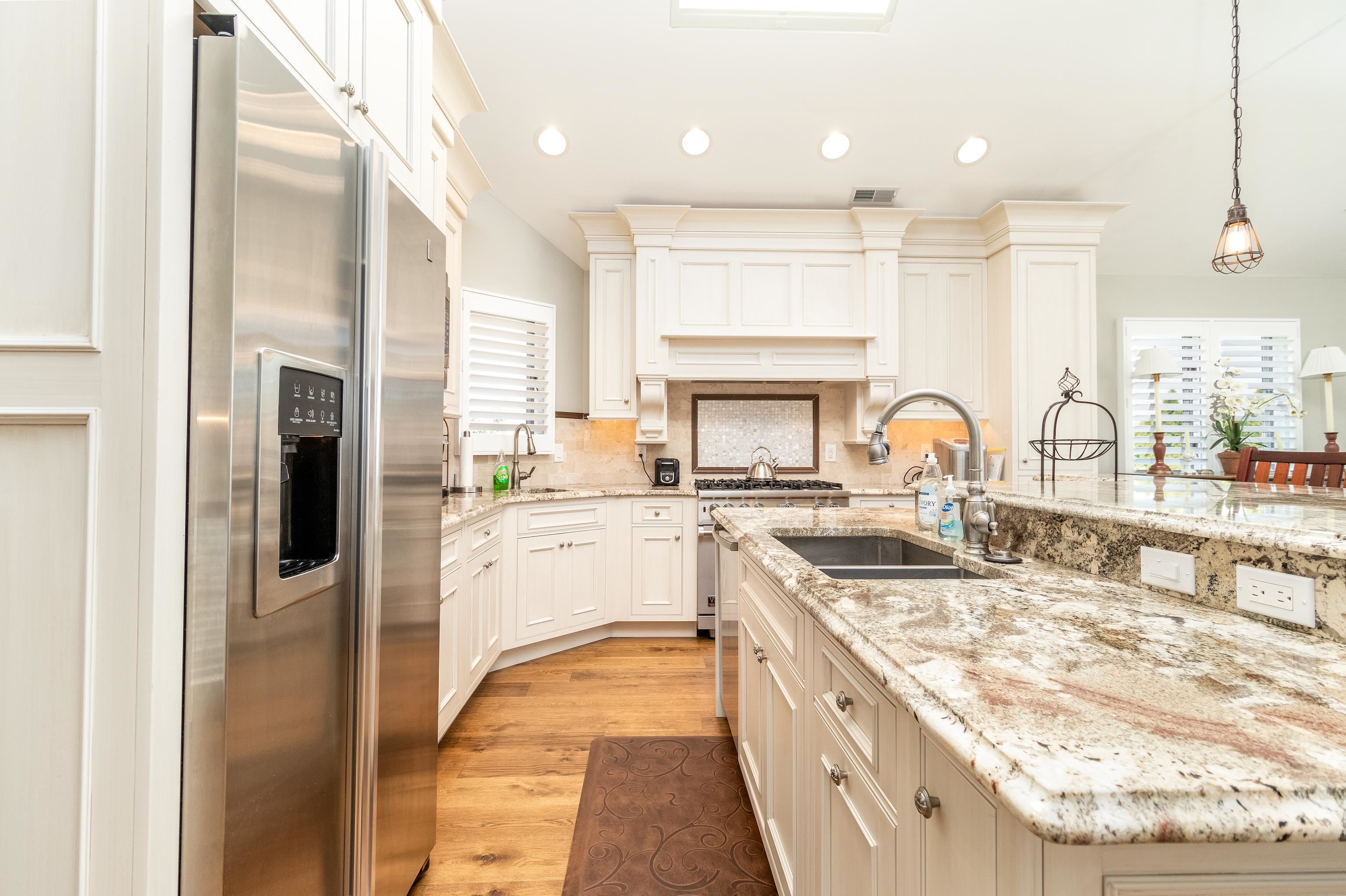 178 37th Street Avalon, NJ 08202 - Photo 11 of 26 a kitchen with stainless steel appliances granite countertop a sink stove and refrigerator