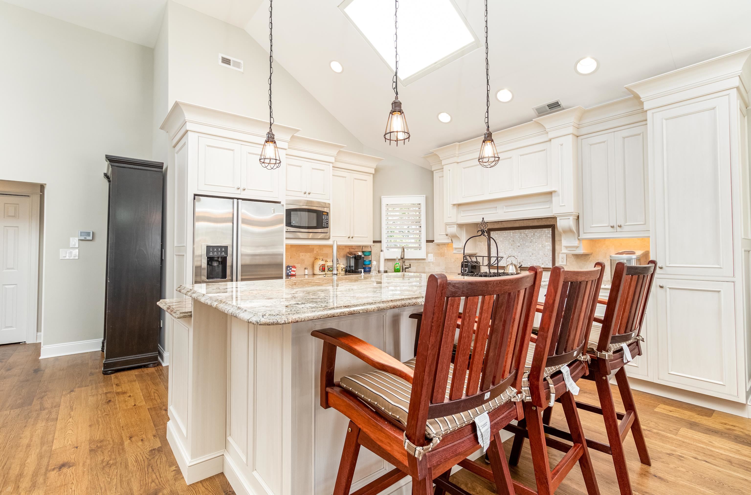 178 37th Street Avalon, NJ 08202 - Photo 12 of 26 a kitchen with a table chairs refrigerator and wooden floor