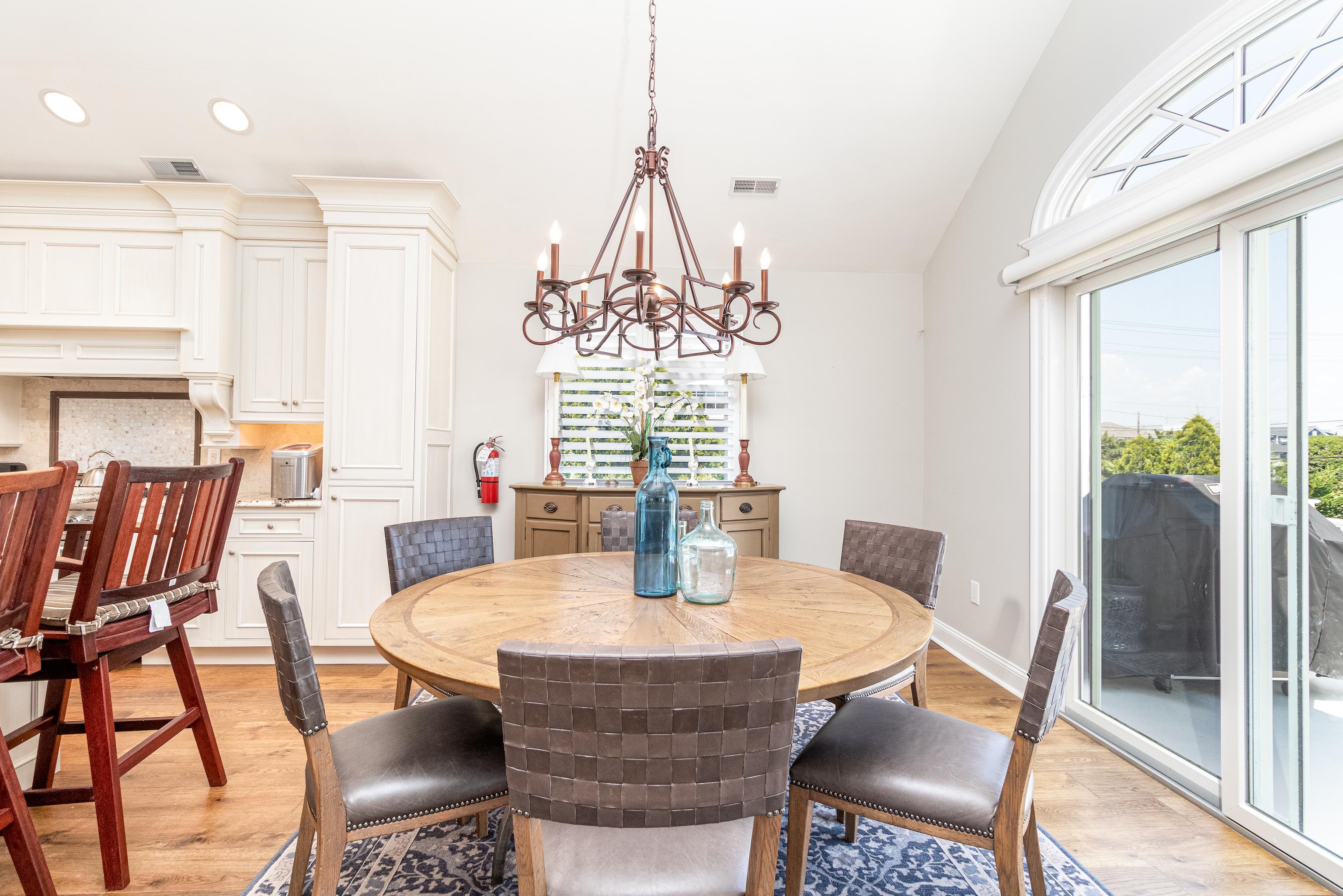 178 37th Street Avalon, NJ 08202 - Photo 14 of 26 a dining room with furniture a chandelier and wooden floor