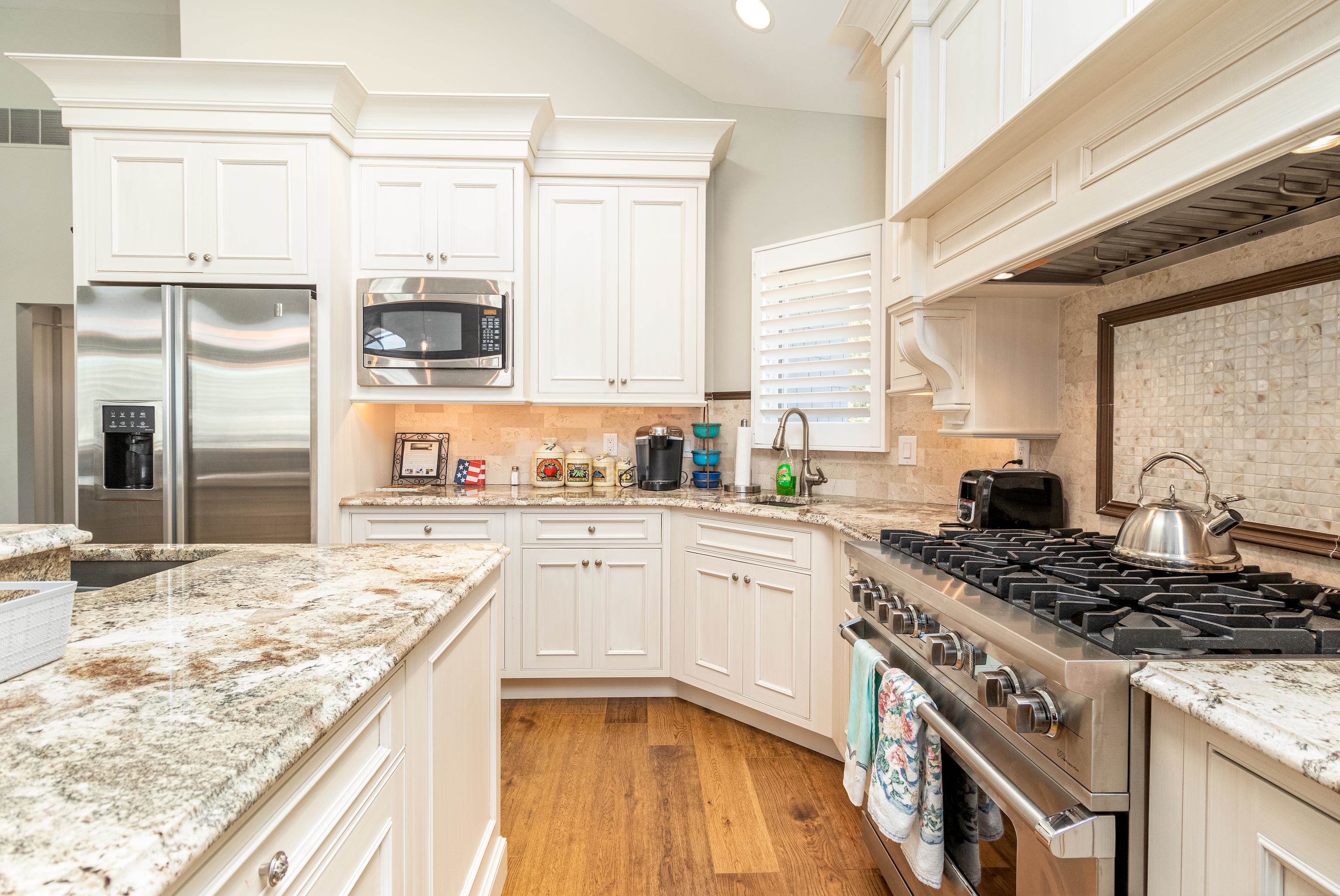 178 37th Street Avalon, NJ 08202 - Photo 15 of 26 a kitchen with stainless steel appliances granite countertop a stove a sink and a microwave